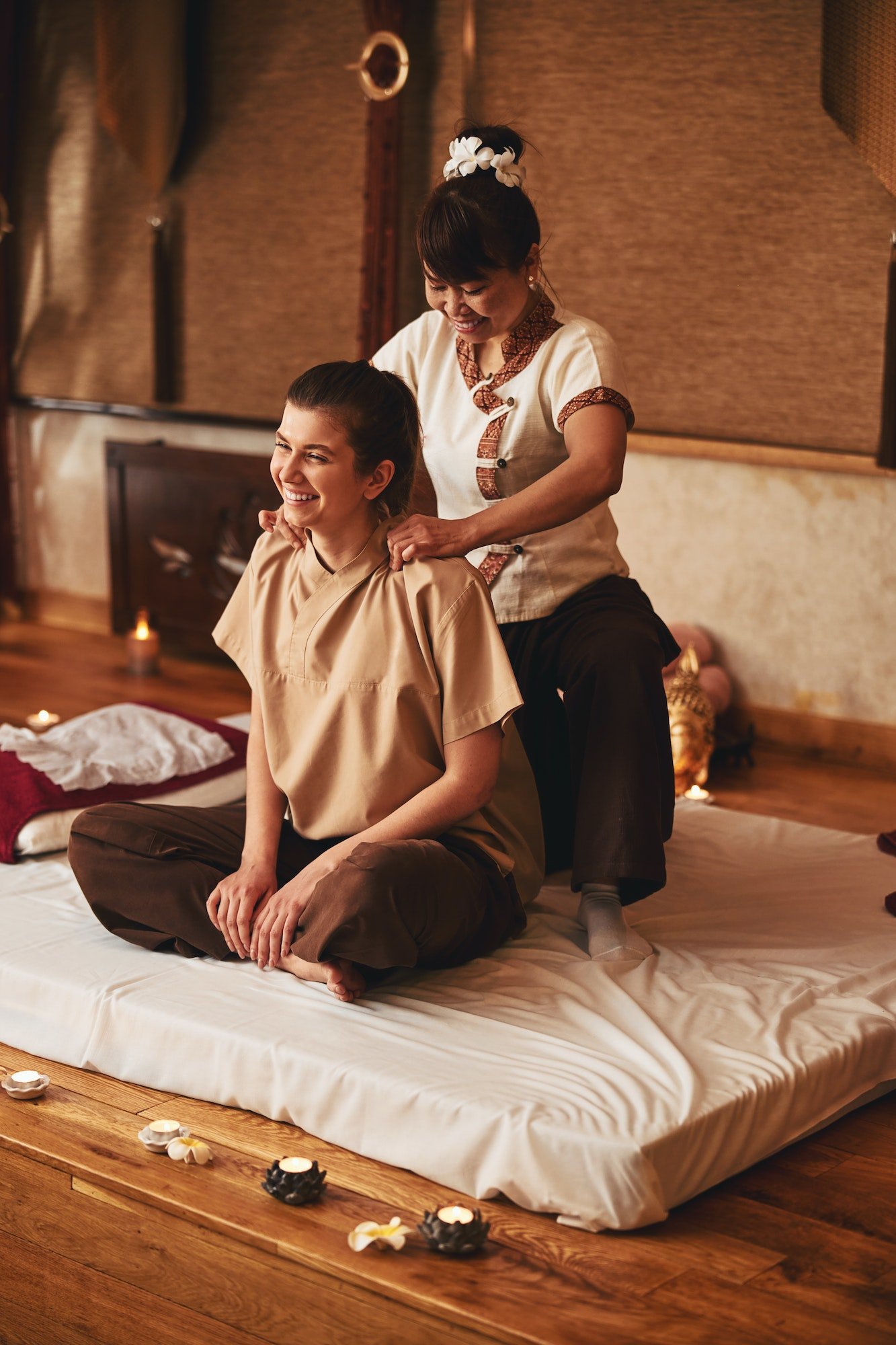 lady-in-lotus-position-receiving-thai-massage-on-neck